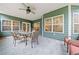 Enclosed sunroom with tile flooring, ample windows, and a comfortable seating area at 120 Laurel Rdg, Canton, GA 30114