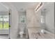 Bathroom with a toilet, large mirror, and vanity with a sink, plus a window at 621 Kenridge Way # 0, Suwanee, GA 30024