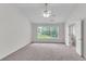 Carpeted bedroom with ceiling fan, large windows, and an en-suite bathroom at 621 Kenridge Way # 0, Suwanee, GA 30024