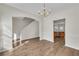 Dining room showing hardwood floors, view to stairway, and view to kitchen at 621 Kenridge Way # 0, Suwanee, GA 30024