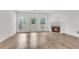 Bright living room featuring a fireplace, hardwood floors, and a glass door to the backyard at 621 Kenridge Way # 0, Suwanee, GA 30024
