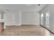 Open concept living room with hardwood floors, large windows and door leading to the backyard at 621 Kenridge Way # 0, Suwanee, GA 30024