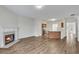 Open-concept living space with hardwood floors, a fireplace, and a view of the kitchen at 621 Kenridge Way # 0, Suwanee, GA 30024