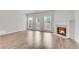 Living room featuring a fireplace, hardwood floors, and a glass door leading to the backyard at 621 Kenridge Way # 0, Suwanee, GA 30024