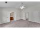 Spacious main bedroom with a ceiling fan, neutral carpet, and ensuite bathroom at 621 Kenridge Way # 0, Suwanee, GA 30024