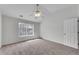 Bedroom featuring neutral carpet, ceiling fan, and a view of a nearby building at 621 Kenridge Way # 0, Suwanee, GA 30024