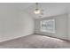 A main bedroom with vaulted ceilings, neutral carpet, and a large window at 621 Kenridge Way # 0, Suwanee, GA 30024