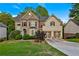 Charming two-story home with a well-manicured lawn and a two-car garage at 6217 Millstone Trl, Douglasville, GA 30135