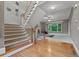 Inviting foyer featuring hardwood floors, a carpeted staircase, and a view into the living room at 6217 Millstone Trl, Douglasville, GA 30135
