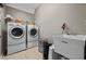 Well-equipped laundry room with washer, dryer, and utility sink at 6217 Millstone Trl, Douglasville, GA 30135