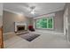 Spacious living room features a fireplace, large windows, and carpeted floors at 6217 Millstone Trl, Douglasville, GA 30135