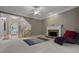 Cozy living room with fireplace, hardwood floors, and a view of the staircase and entry at 6217 Millstone Trl, Douglasville, GA 30135