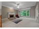 Comfortable living room featuring a stone fireplace and a large picture window at 6217 Millstone Trl, Douglasville, GA 30135