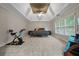 Spacious main bedroom with a tray ceiling, ceiling fan, and large windows offering natural light at 6217 Millstone Trl, Douglasville, GA 30135