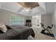 Large main bedroom features a tray ceiling, fan, access to the ensuite bathroom, and an exercise area at 6217 Millstone Trl, Douglasville, GA 30135