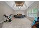 Spacious main bedroom featuring tray ceiling, ceiling fan, sitting area, and large windows with natural light at 6217 Millstone Trl, Douglasville, GA 30135