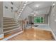 Carpeted staircase leading to a room with a fireplace and large picture window at 6217 Millstone Trl, Douglasville, GA 30135