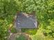 Aerial view of the home highlighting its privacy, surrounded by lush trees and well-maintained roof at 6650 Bobby John Rd, Atlanta, GA 30349