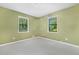 Bedroom featuring soft carpet, natural lighting, and a pleasant view from both windows at 6650 Bobby John Rd, Atlanta, GA 30349