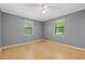 Bedroom with wood floors, light gray walls, and bright, natural light from windows at 6650 Bobby John Rd, Atlanta, GA 30349