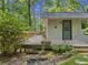 Home featuring deck, side entrance, stone steps, and rock lined flower garden at 6650 Bobby John Rd, Atlanta, GA 30349