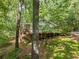 Exterior of home with wooden deck overlooking a lush green yard and surrounded by trees at 6650 Bobby John Rd, Atlanta, GA 30349