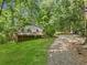 View of house with a nice yard, side deck, and long gravel driveway at 6650 Bobby John Rd, Atlanta, GA 30349