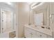 Well-lit bathroom features a white vanity, a large mirror, and neutral tones, offering a clean and simple design at 790 Sienna Dr, Cumming, GA 30040