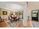 Elegant dining room features hardwood floors, a chandelier, and wainscoting at 790 Sienna Dr, Cumming, GA 30040