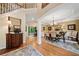 Spacious dining room with wood floors, tray ceiling, and views into the living area at 790 Sienna Dr, Cumming, GA 30040