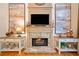 Living room fireplace with stone accents, a decorative mantle, and modern design elements at 790 Sienna Dr, Cumming, GA 30040