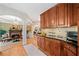 A kitchen featuring custom cabinets, hardwood floors and flows into the living room with fireplace at 790 Sienna Dr, Cumming, GA 30040