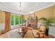 A living room with a fireplace, beautiful window with view, natural light, and hardwood floors at 790 Sienna Dr, Cumming, GA 30040