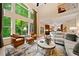 Sunlit living room with soaring windows and views of the wooded backyard and open floorplan at 790 Sienna Dr, Cumming, GA 30040
