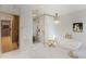Bright bathroom featuring a soaking tub, glass enclosed shower, and access to a large walk-in closet at 1 Habersham Nw Way, Atlanta, GA 30305