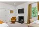 Bedroom featuring cozy sitting area with fireplace, TV and a large window with curtains at 1 Habersham Nw Way, Atlanta, GA 30305