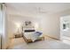 Bright bedroom with natural light, neutral walls, wood flooring, ceiling fan, and a cozy bed at 1 Habersham Nw Way, Atlanta, GA 30305