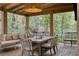 Covered patio with wood floors, outdoor seating and a dining table at 1 Habersham Nw Way, Atlanta, GA 30305