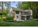 Stunning white brick home exterior with black-trimmed windows surrounded by lush greenery and manicured landscaping at 1 Habersham Nw Way, Atlanta, GA 30305