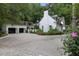 Elegant white brick home with a spacious driveway and a detached two-car garage at 1 Habersham Nw Way, Atlanta, GA 30305