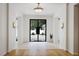 Elegant foyer features a modern light fixture and a black framed glass front door at 1 Habersham Nw Way, Atlanta, GA 30305
