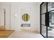 Bright foyer with hardwood floors, modern lighting, and a striking circular art piece at 1 Habersham Nw Way, Atlanta, GA 30305