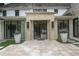 Stunning front entrance with a stone surround, modern black door, and manicured landscaping at 1 Habersham Nw Way, Atlanta, GA 30305
