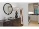 Hallway featuring modern decor, dresser, round mirror, and convenient access to the laundry room at 1 Habersham Nw Way, Atlanta, GA 30305