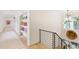 Hallway with shelving and a staircase featuring black iron railings and a unique wall decoration at 1 Habersham Nw Way, Atlanta, GA 30305