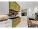 Elegant kitchen with green accents, stainless steel appliances, and designer finishes at 1 Habersham Nw Way, Atlanta, GA 30305
