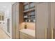 Kitchen featuring light wood cabinets, built in shelves, drawers, and beverage refrigerator at 1 Habersham Nw Way, Atlanta, GA 30305