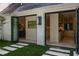 Bifold doors reveal a sunlit kitchen featuring high-end appliances and sleek, modern design at 1 Habersham Nw Way, Atlanta, GA 30305
