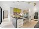 Modern kitchen with an island, bar stool seating, white cabinets, and a stainless steel fridge at 1 Habersham Nw Way, Atlanta, GA 30305