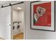 Laundry room with new washer and dryer set behind a sliding barn door with art at 1 Habersham Nw Way, Atlanta, GA 30305